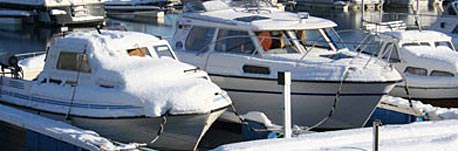 The snow in October covering boats on the Cheboygan River.